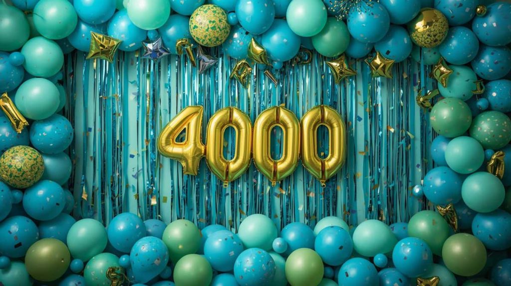 balloons and streamers in blues and greens surrounding gold mylar balloons that say 4000