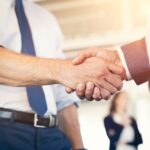 close up view of two men shaking hands