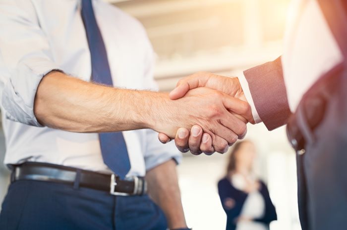 close up view of two men shaking hands